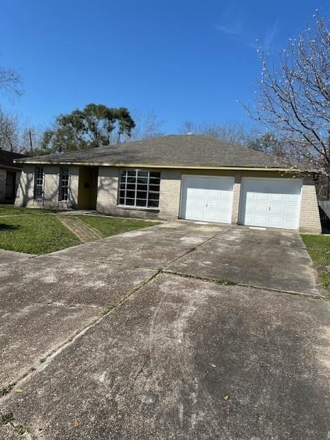 ranch-style house featuring a garage, driveway, brick siding, and a front lawn