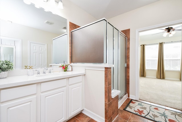 bathroom with vanity, visible vents, a ceiling fan, a shower stall, and tile patterned floors