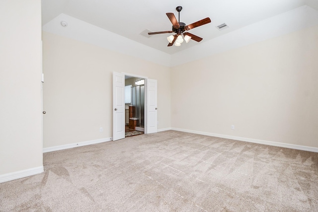 carpeted empty room with a ceiling fan, visible vents, and baseboards