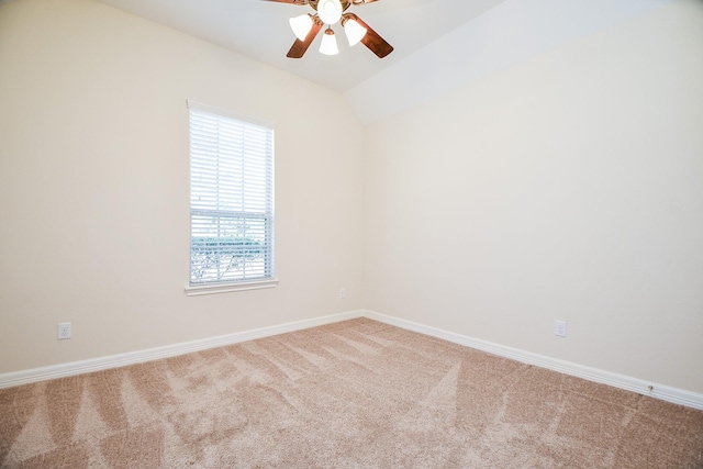 carpeted empty room featuring ceiling fan, baseboards, and vaulted ceiling