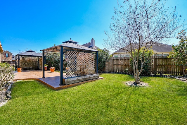 view of yard featuring a gazebo, a patio, and a fenced backyard