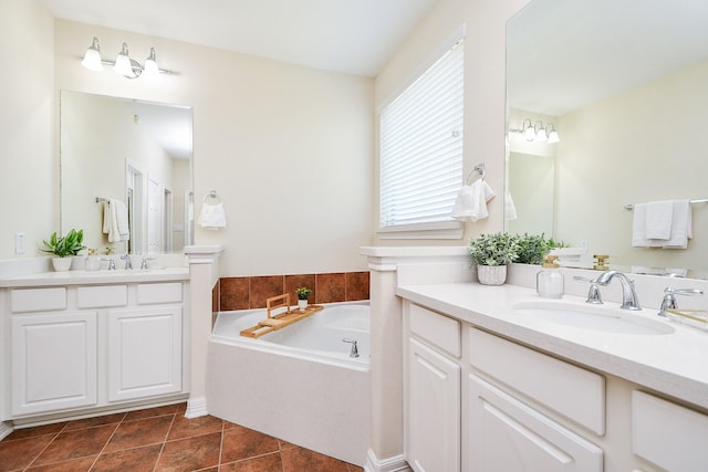 bathroom featuring two vanities, tile patterned flooring, a sink, and a bath