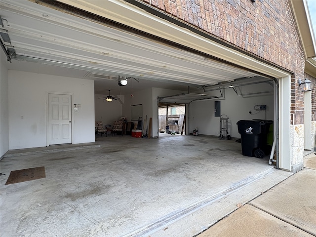 garage with electric panel and a garage door opener