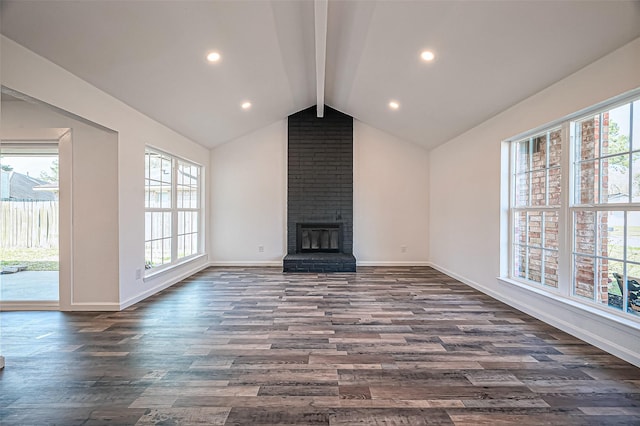 unfurnished living room with baseboards, dark wood finished floors, lofted ceiling with beams, a fireplace, and recessed lighting