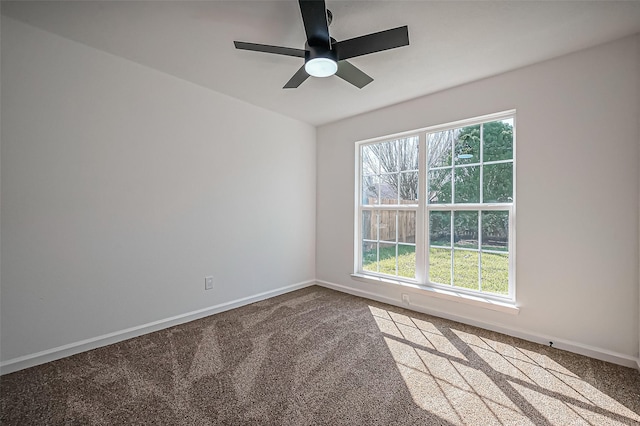 unfurnished room with carpet floors, baseboards, and a ceiling fan