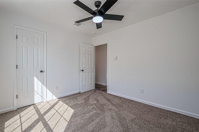 unfurnished bedroom featuring ceiling fan, visible vents, baseboards, and carpet flooring