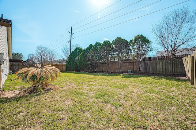 view of yard with a fenced backyard