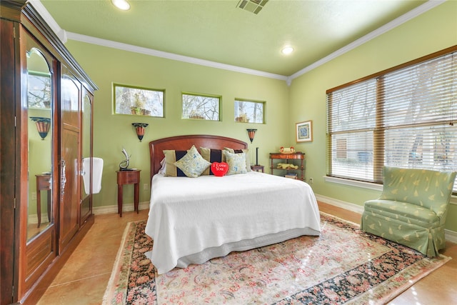 bedroom with ornamental molding, tile patterned flooring, visible vents, and baseboards