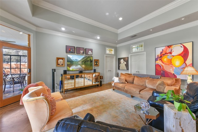 living area with a tray ceiling, ornamental molding, and recessed lighting