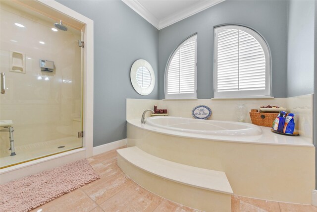 bathroom with a garden tub, tile patterned flooring, baseboards, a shower stall, and crown molding