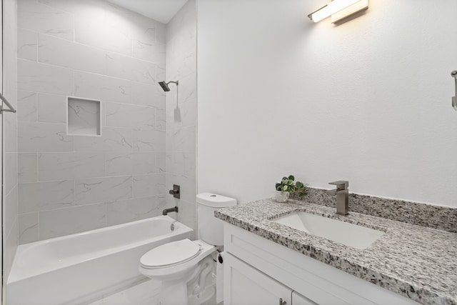 bathroom featuring toilet, marble finish floor, vanity, and washtub / shower combination