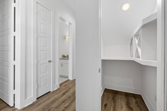 hall featuring baseboards and wood finished floors