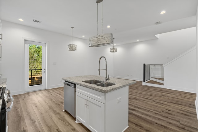 kitchen with a sink, appliances with stainless steel finishes, visible vents, white cabinetry, and light wood-style floors