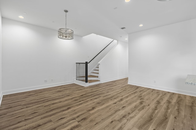 interior space with wood finished floors, stairway, baseboards, visible vents, and recessed lighting