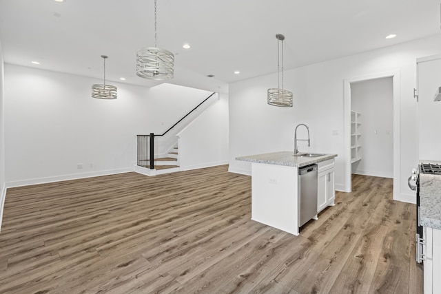 kitchen featuring recessed lighting, dishwasher, a sink, white cabinets, and light wood-type flooring