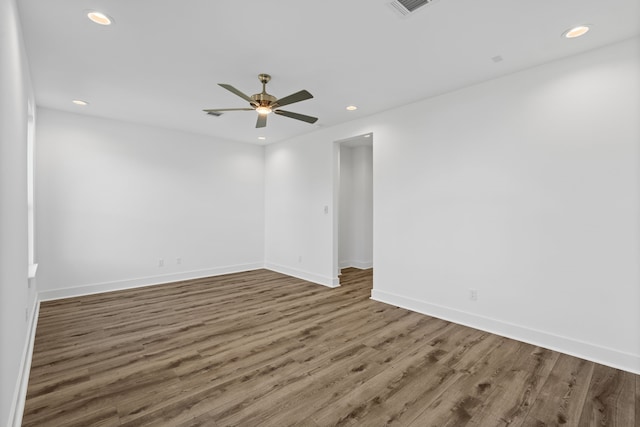 unfurnished room featuring wood finished floors, a ceiling fan, visible vents, baseboards, and recessed lighting