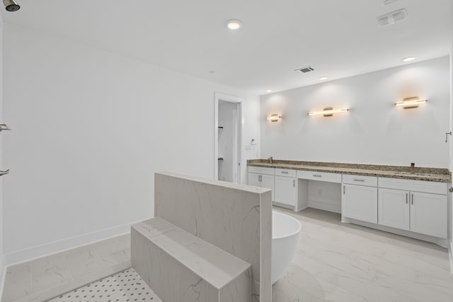 full bathroom featuring a sink, a freestanding bath, marble finish floor, and visible vents