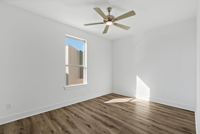 empty room with baseboards, a ceiling fan, and wood finished floors