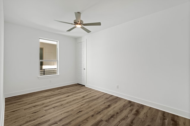 unfurnished room with baseboards, a ceiling fan, and wood finished floors