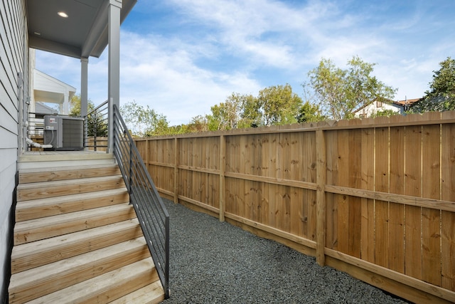 view of yard featuring fence and cooling unit