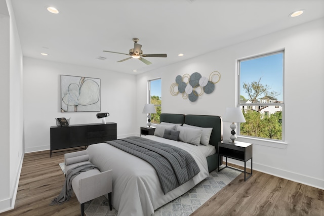 bedroom featuring a ceiling fan, wood finished floors, baseboards, and recessed lighting