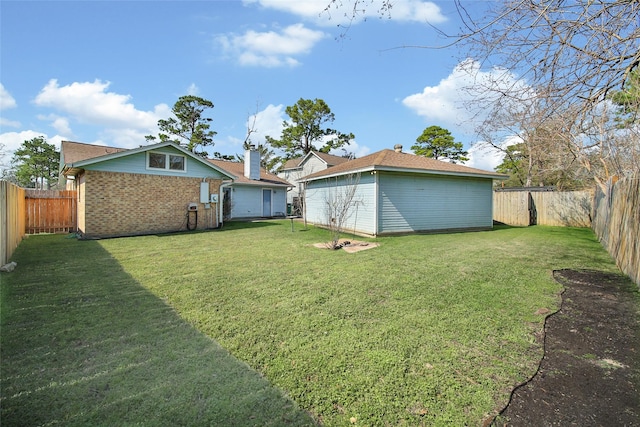 view of yard featuring an outbuilding and a fenced backyard