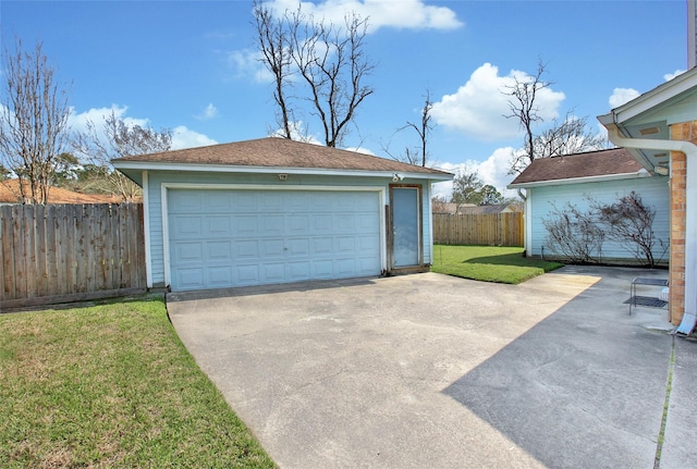 detached garage featuring fence