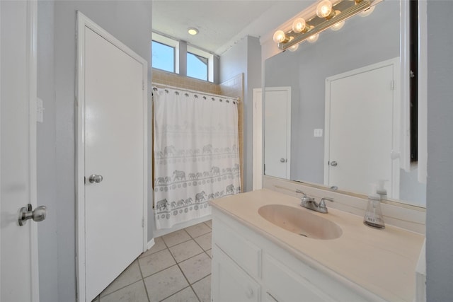 full bathroom with a shower with shower curtain, vanity, a textured ceiling, and tile patterned floors