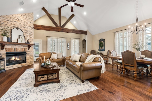 living room featuring visible vents, arched walkways, wood finished floors, and a stone fireplace