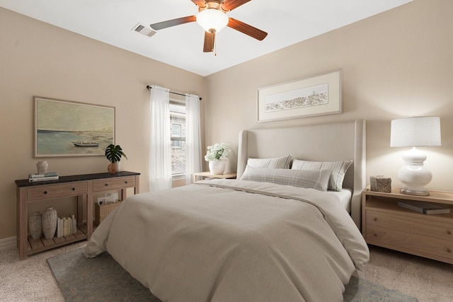 carpeted bedroom with visible vents and ceiling fan