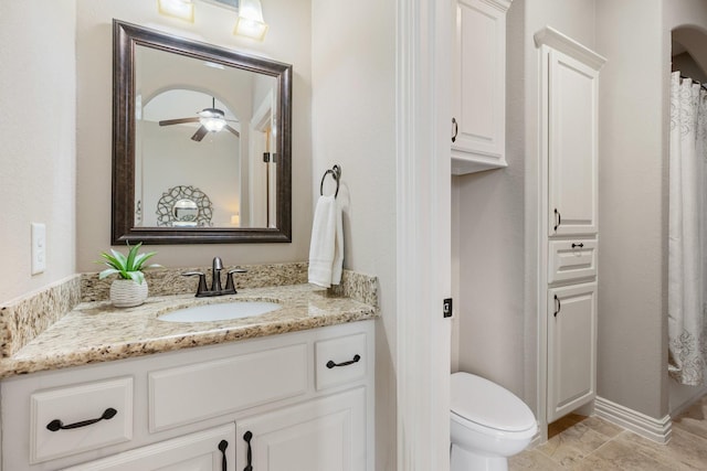 full bathroom with a ceiling fan, baseboards, vanity, and toilet