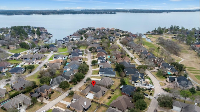 drone / aerial view featuring a water view and a residential view