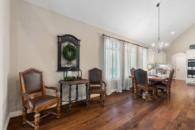 dining room with lofted ceiling, dark wood-style flooring, baseboards, and an inviting chandelier