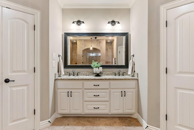 bathroom with crown molding, a walk in shower, and a sink