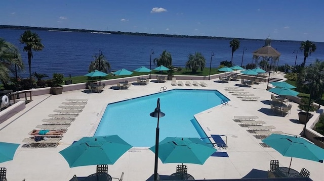 pool with a water view and a patio area