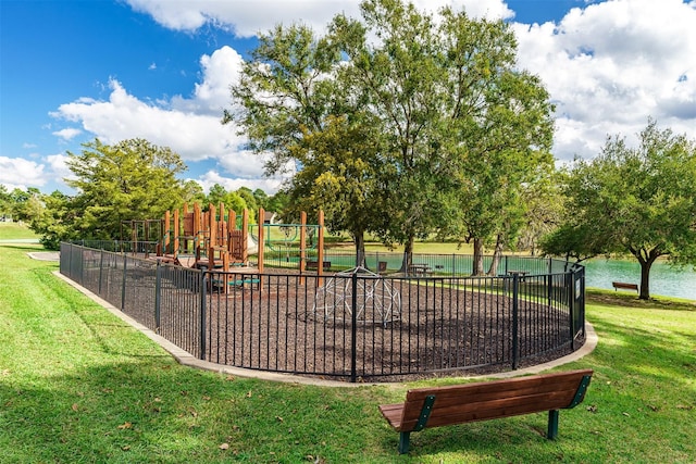 view of property's community featuring playground community and a yard