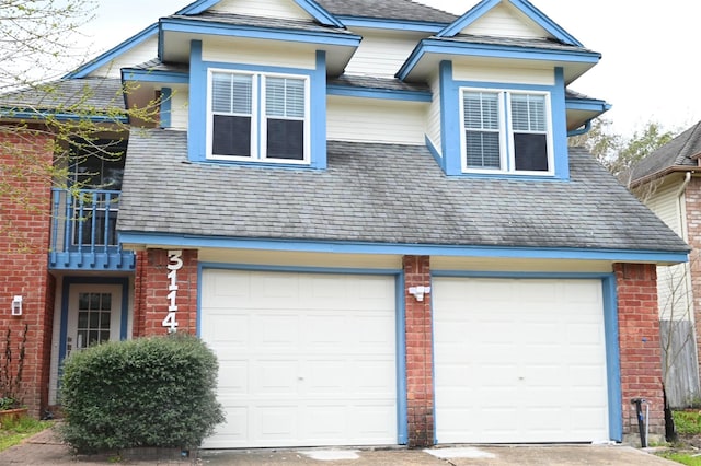 view of home's exterior with driveway, an attached garage, and brick siding