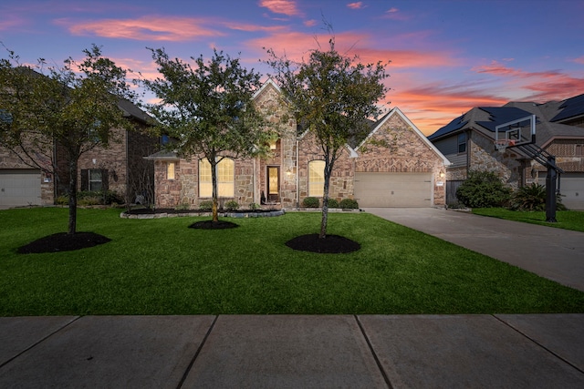 view of front facade featuring a garage, concrete driveway, and a lawn