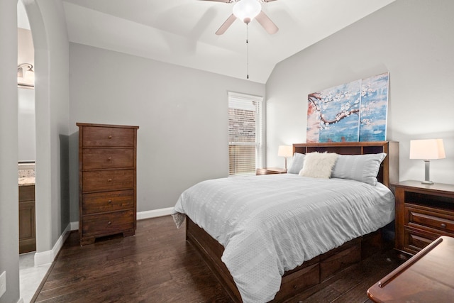 bedroom with arched walkways, lofted ceiling, a ceiling fan, wood finished floors, and baseboards