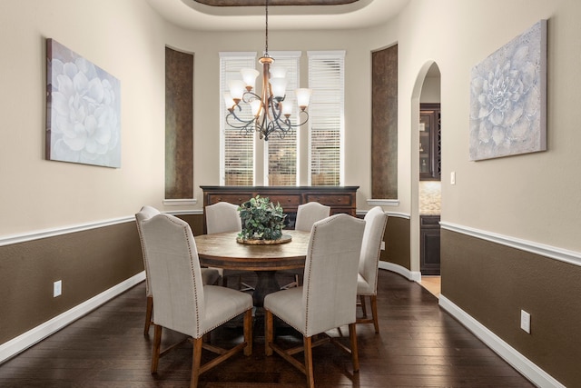 18419 Harlow Dr, Tomball, TX 77377 - dining room featuring dark wood-style floors, a chandelier, arched walkways, and baseboards
