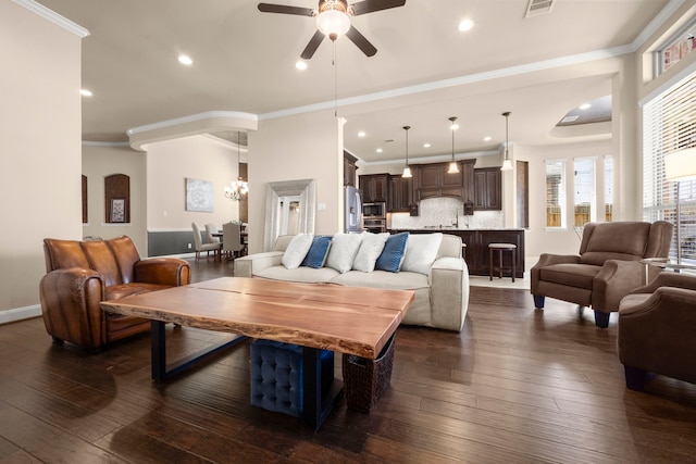 living area with dark wood-style flooring, crown molding, and baseboards