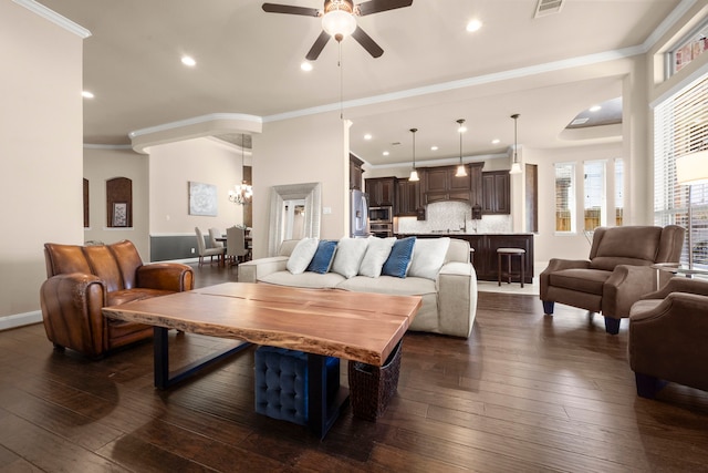 18419 Harlow Dr, Tomball, TX 77377 - living room with a ceiling fan, a chandelier, dark wood-style flooring, recessed lighting, and crown molding