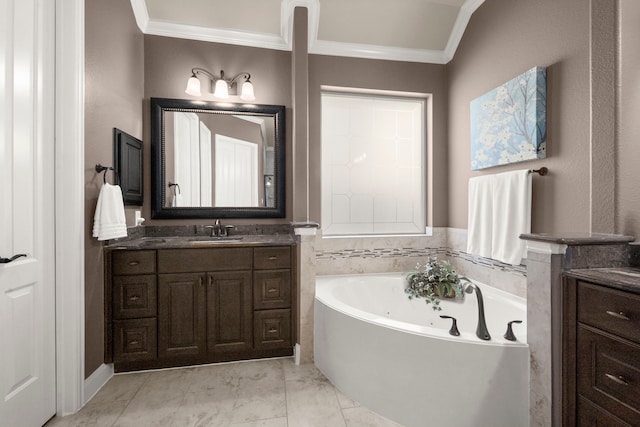 bathroom featuring crown molding, vanity, and a tub with jets