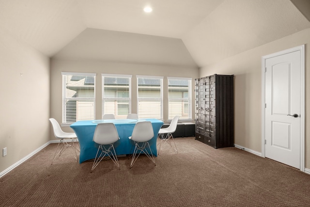 dining space with carpet flooring, vaulted ceiling, and baseboards