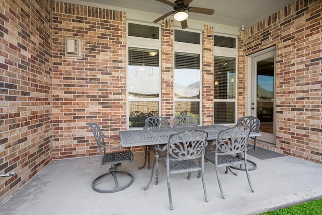 view of patio with outdoor dining space and ceiling fan