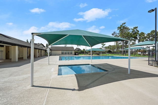 pool featuring a patio and fence