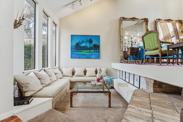 living room with lofted ceiling and track lighting