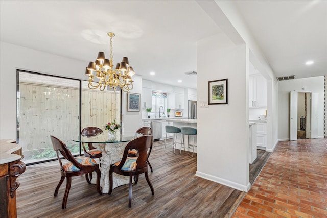 dining room featuring a chandelier, brick floor, recessed lighting, visible vents, and baseboards