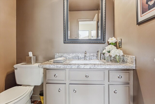 half bath with vanity and toilet