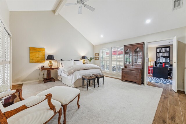 bedroom with visible vents, ceiling fan, wood finished floors, high vaulted ceiling, and beam ceiling